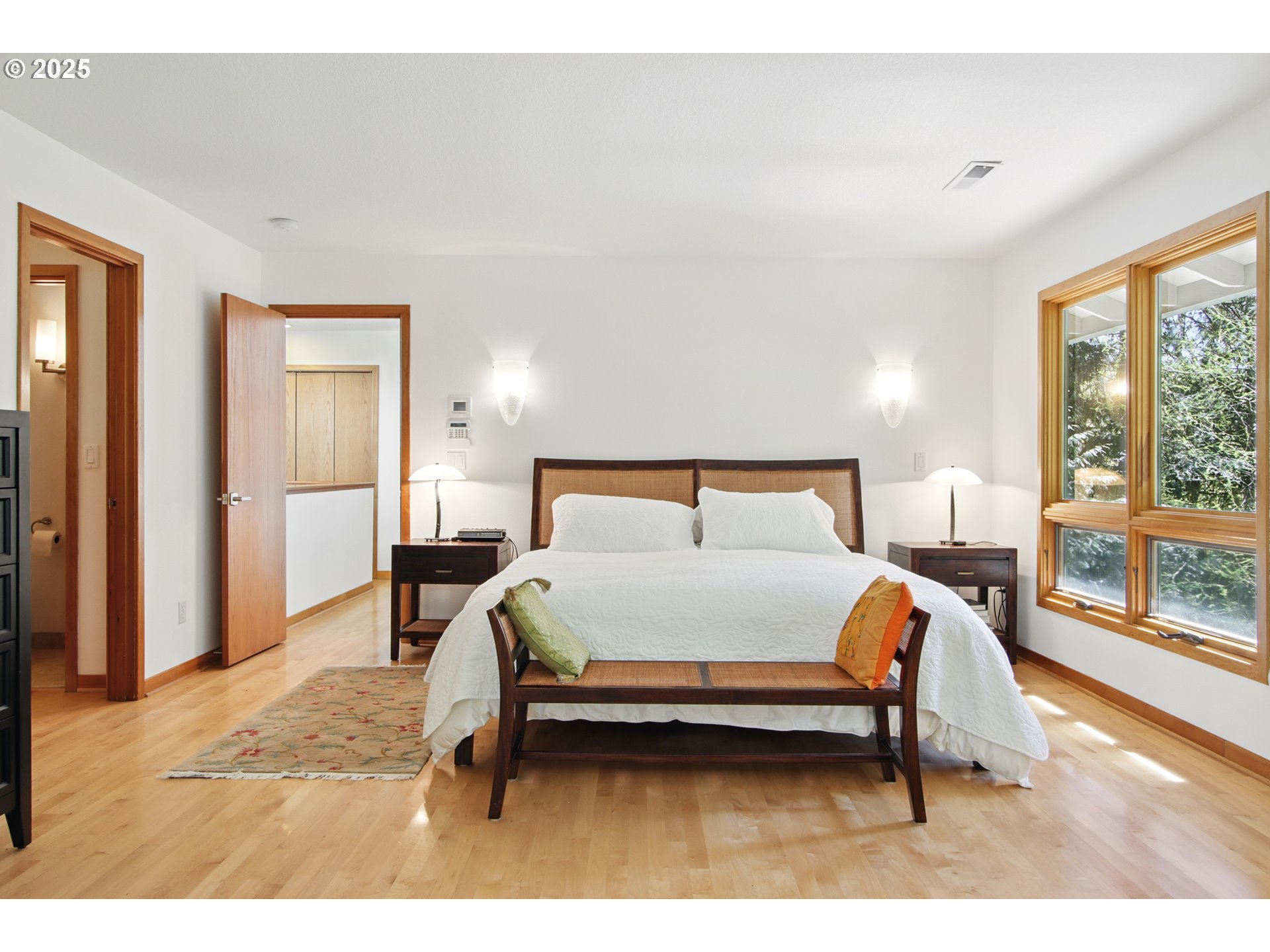 6335 Northwest Cornell Road Portland, OR 97210 - Photo 18 of 41 a bedroom with a bed a large window with outer view and balcony view