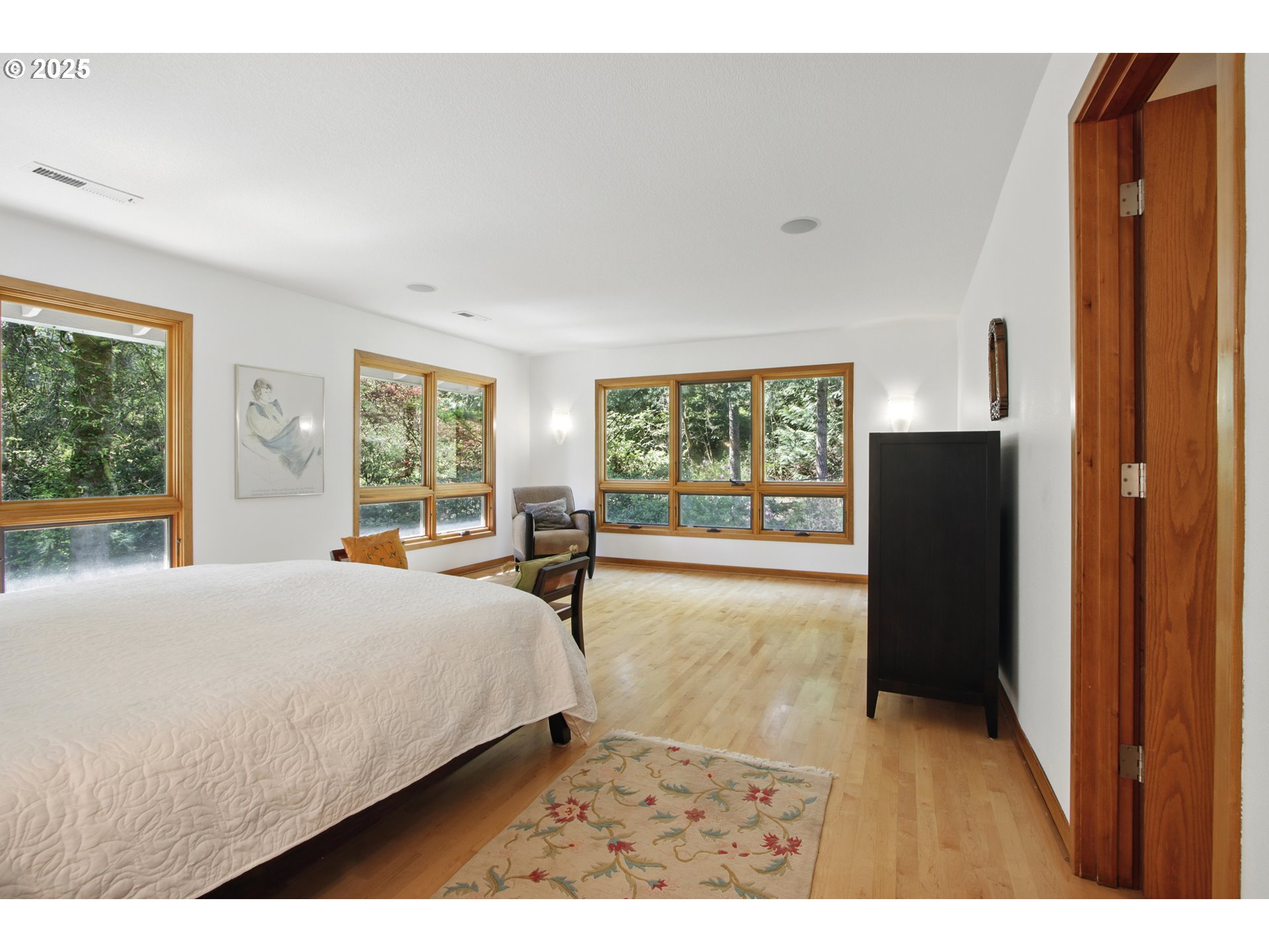 6335 Northwest Cornell Road Portland, OR 97210 - Photo 19 of 41 a bedroom with a bed and wooden floor