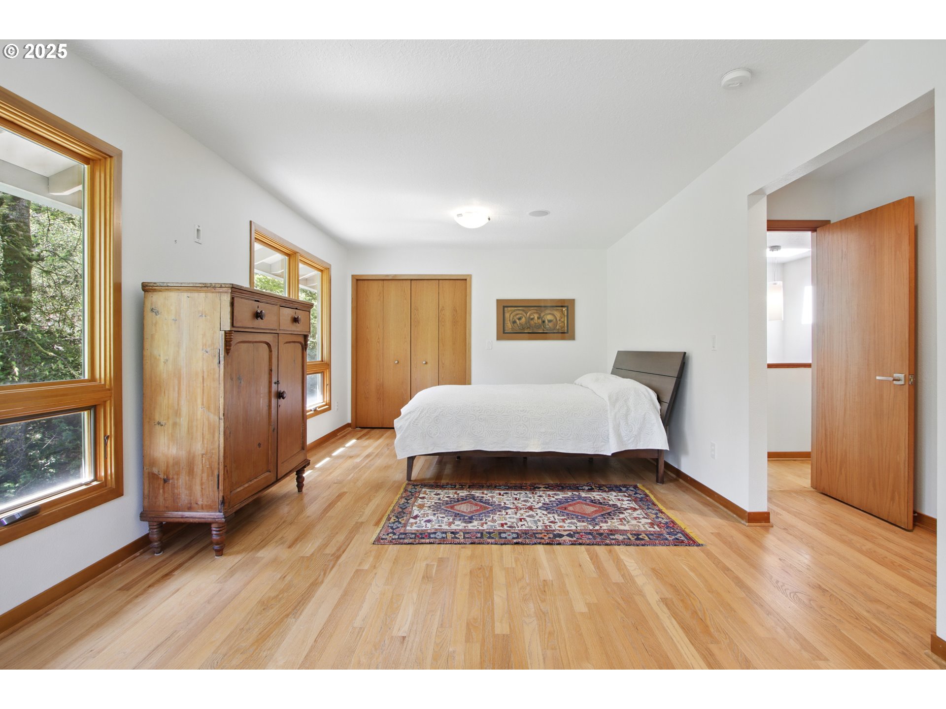 6335 Northwest Cornell Road Portland, OR 97210 - Photo 24 of 41 a spacious bedroom with a bed and wooden floor