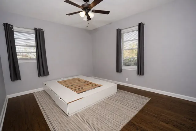a view of hallway with wooden floor and chandelier
