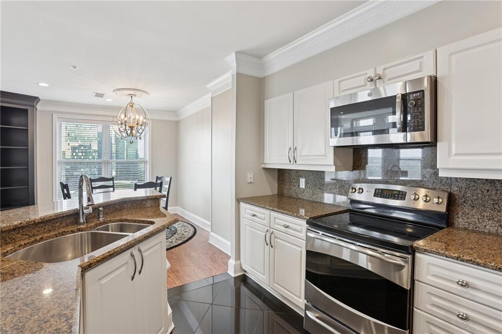 a kitchen with stainless steel appliances granite countertop a sink stove and oven