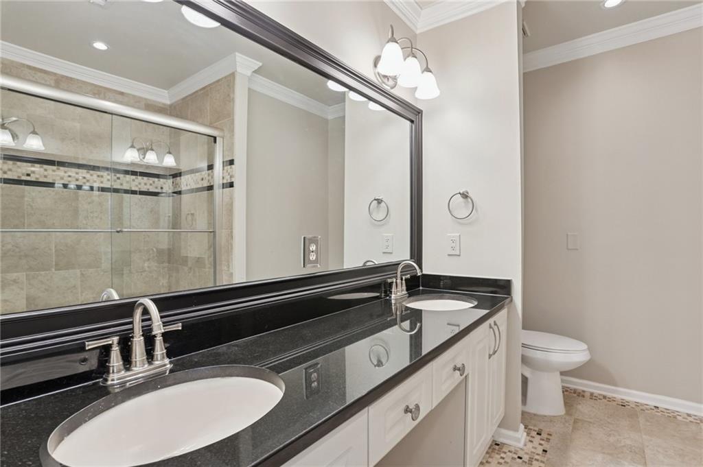 3334 Peachtree Road Northeast, Unit 1109 Atlanta, GA 30326 - Photo 14 of 27 a bathroom with a sink and a mirror