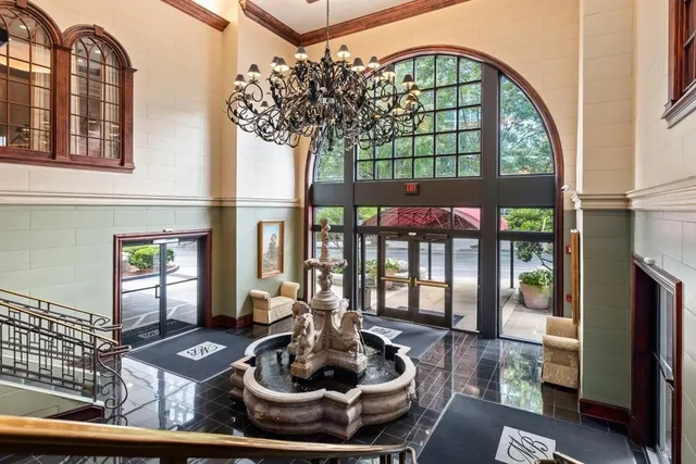a living room with furniture fireplace and a large window