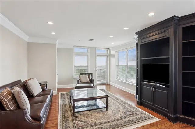 a living room with furniture rug and a flat screen tv