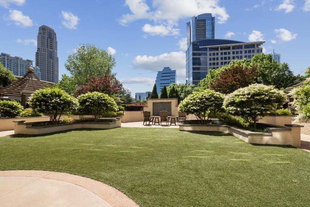 3334 Peachtree Road Northeast, Unit 1109 Atlanta, GA 30326 - Photo 24 of 27 a swimming pool with outdoor seating and garden