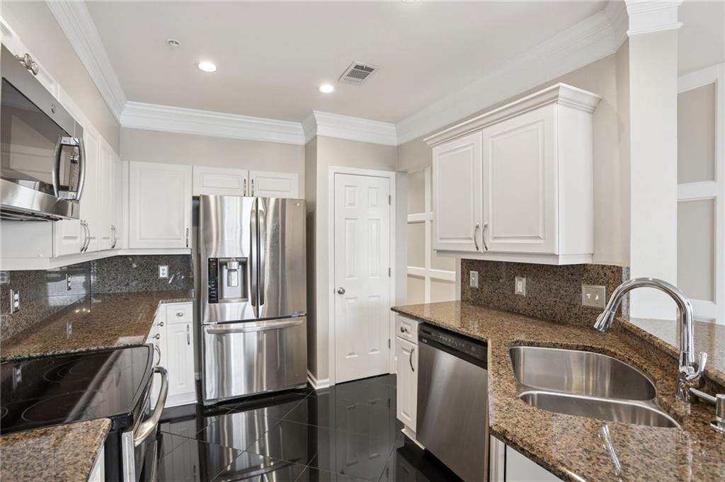 3334 Peachtree Road Northeast, Unit 1109 Atlanta, GA 30326 - Photo 3 of 27 a kitchen with a refrigerator sink and cabinets