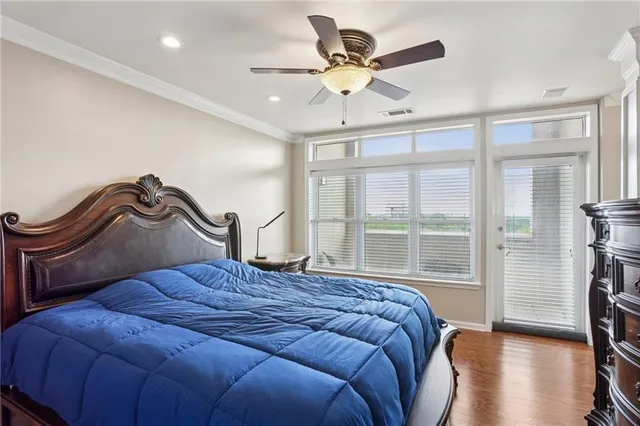 a bedroom with a bed and a large window