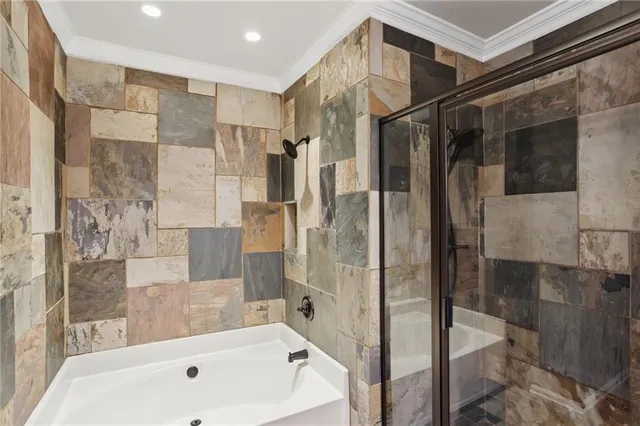 a bathroom with a bathtub and a shower