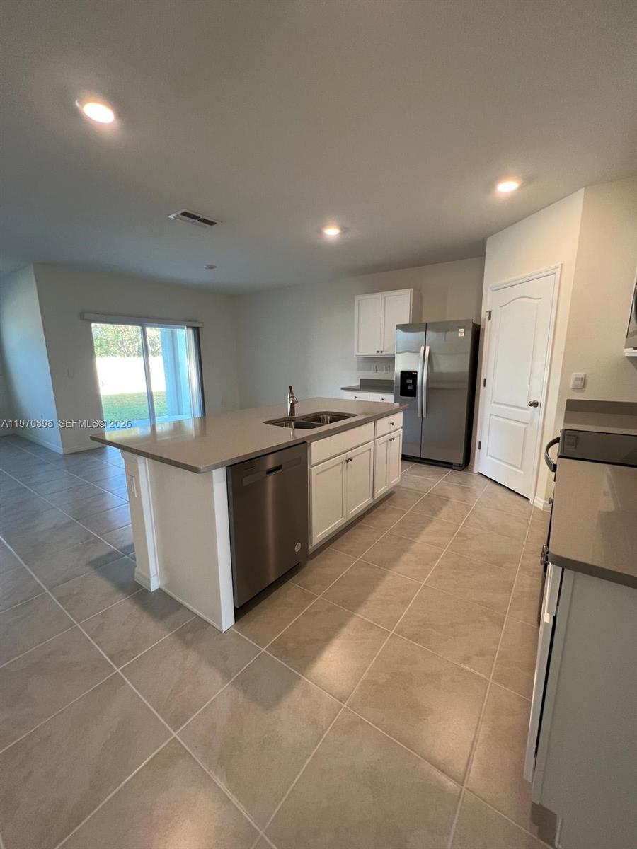 2710 Trinidad Road Haines City, FL 33844 - Photo 2 of 13 a large kitchen with a large counter top stainless steel appliances and cabinets