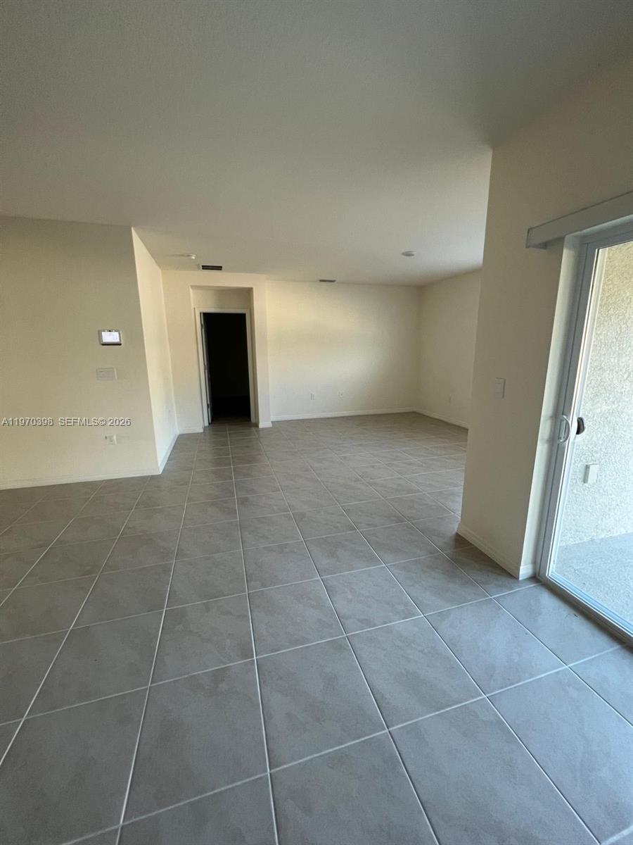 2710 Trinidad Road Haines City, FL 33844 - Photo 8 of 13 a view of an empty room with a fireplace and a window