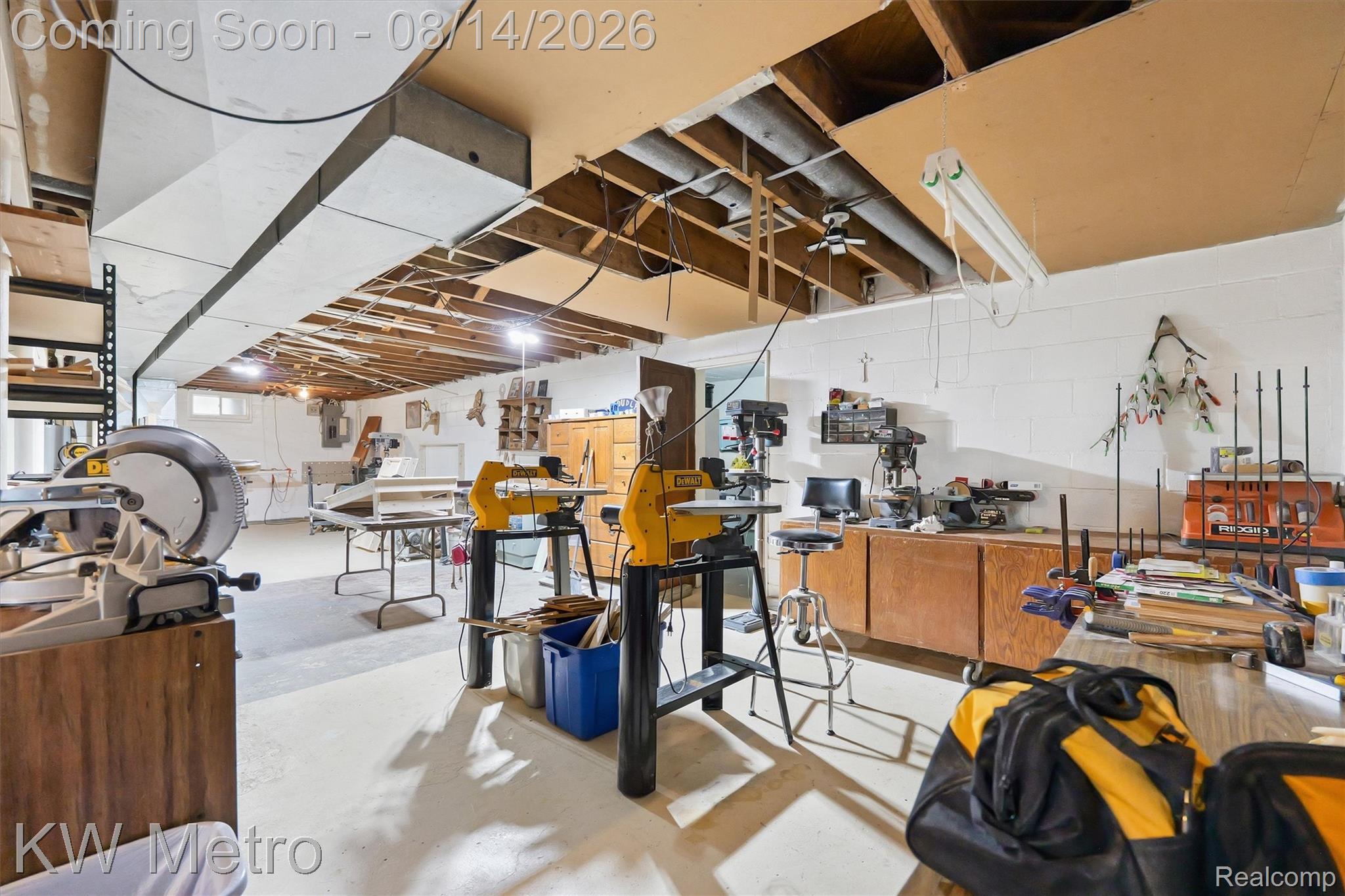 201 South Maple Leaf Road Lapeer, MI 48446 - Photo 30 of 70 Workshop space with concrete flooring, exposed ceiling joists, and built-in wood cabinetry