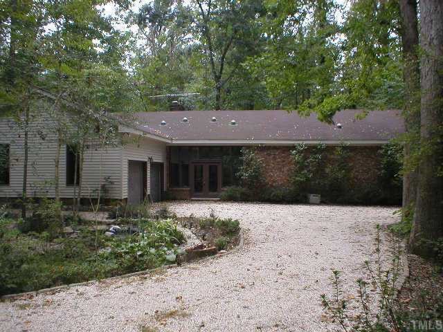 8005 Rotterdam Court Raleigh, NC 27606 - Photo 1 of 1 Secluded contemporary brick ranch w/ new vinyl siding on 1.49 heavily wooded acres for privacy