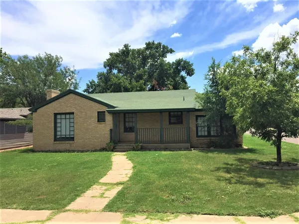 a front view of house with yard and trees