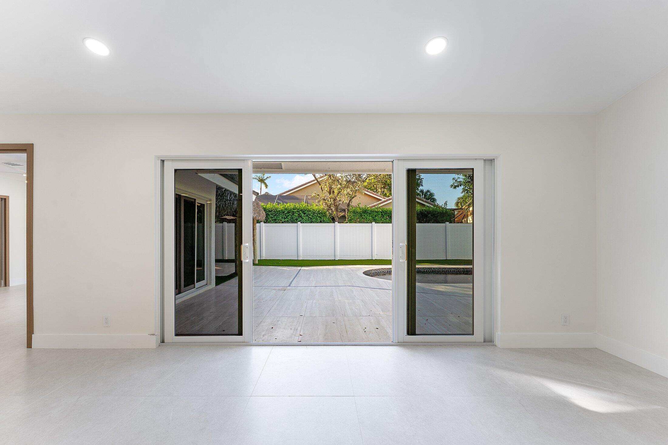 1380 Southwest 1st Street Boca Raton, FL 33486 - Photo 14 of 50 an empty room with floor to ceiling window and an outdoor view