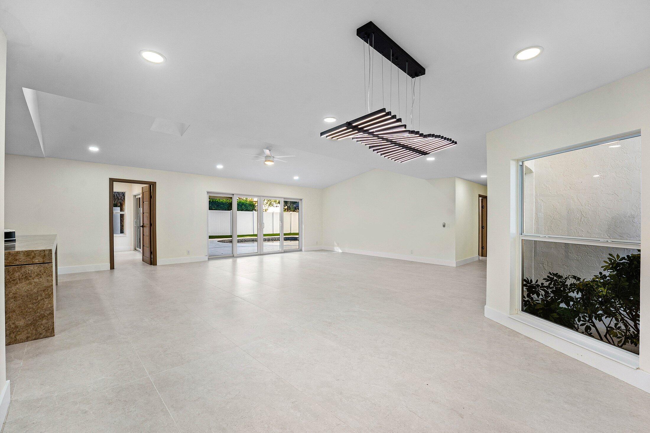 1380 Southwest 1st Street Boca Raton, FL 33486 - Photo 17 of 50 an empty room with chandelier fan and windows