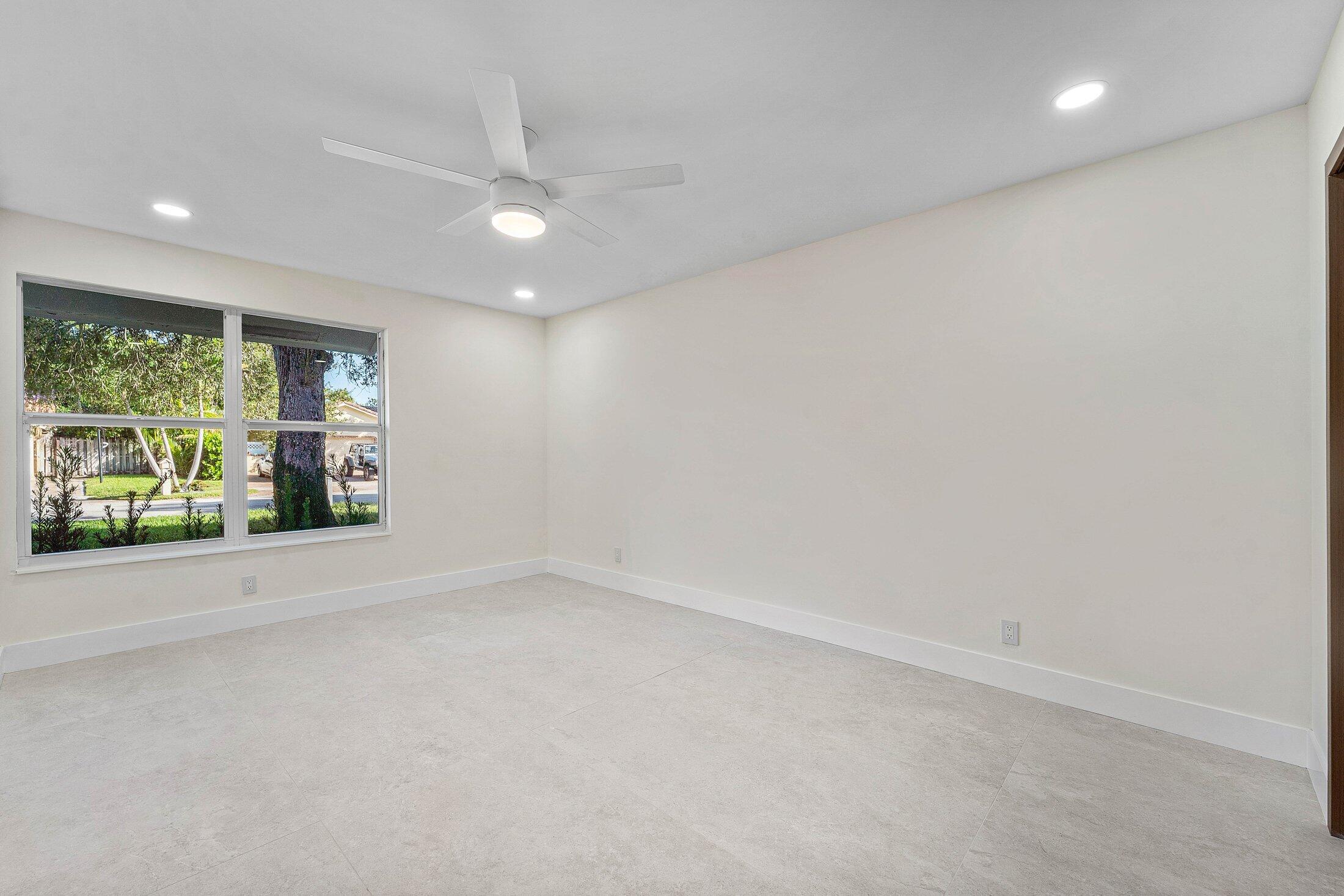 1380 Southwest 1st Street Boca Raton, FL 33486 - Photo 18 of 50 an empty room with wooden floor and windows