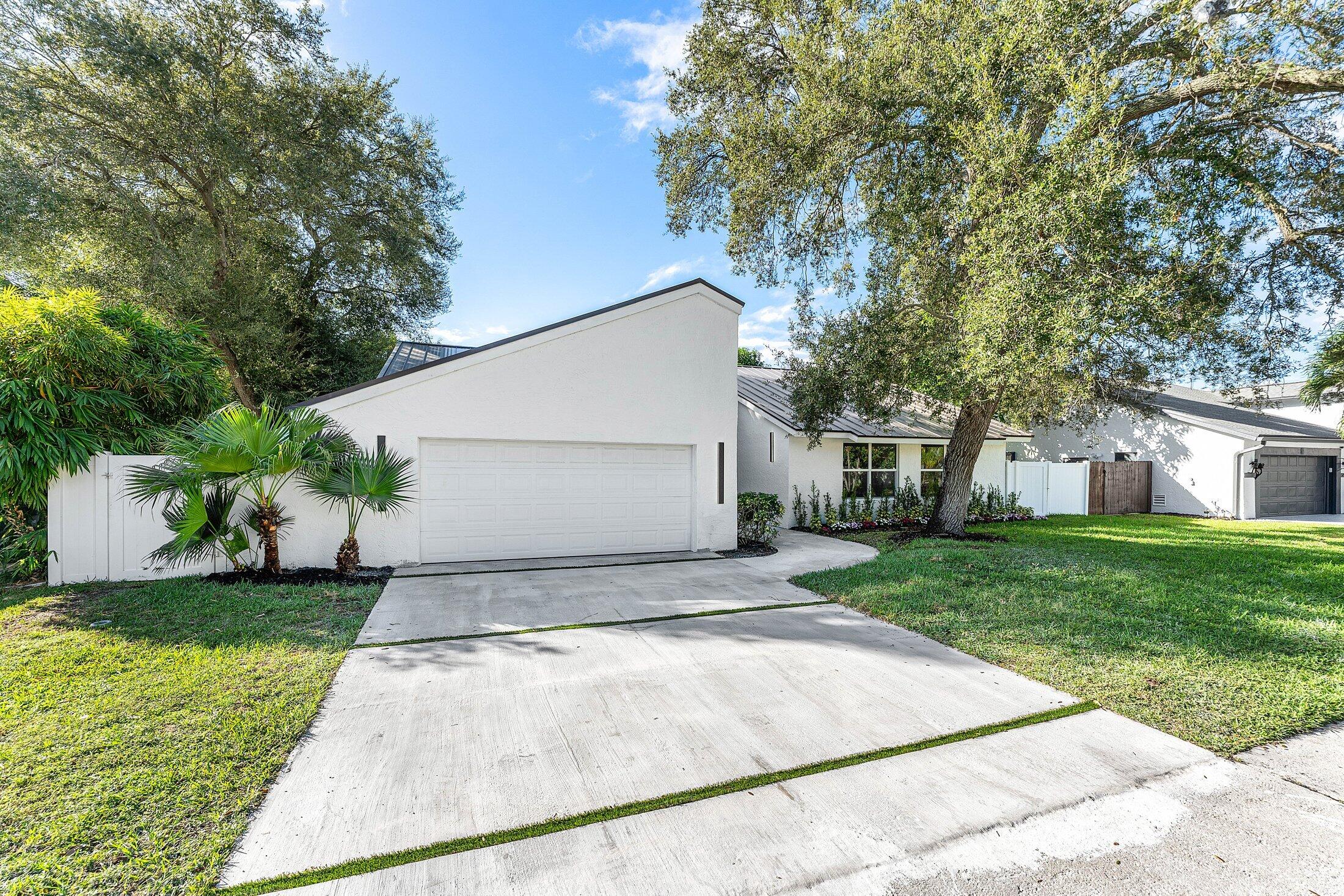 1380 Southwest 1st Street Boca Raton, FL 33486 - Photo 2 of 50 a view of a house with a yard and a large tree