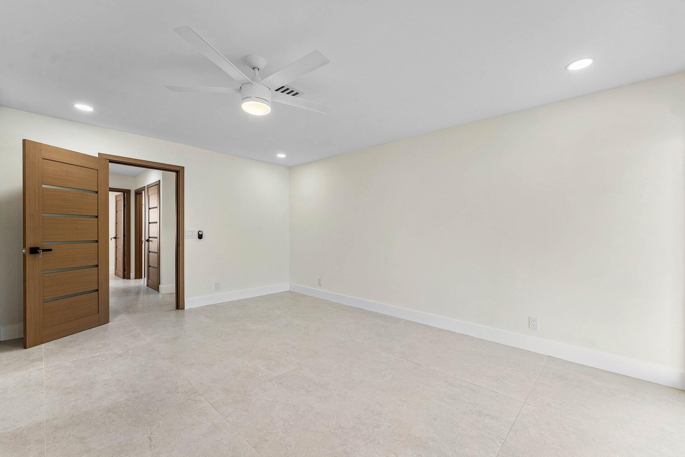 1380 Southwest 1st Street Boca Raton, FL 33486 - Photo 25 of 50 an empty room with closet and wooden door