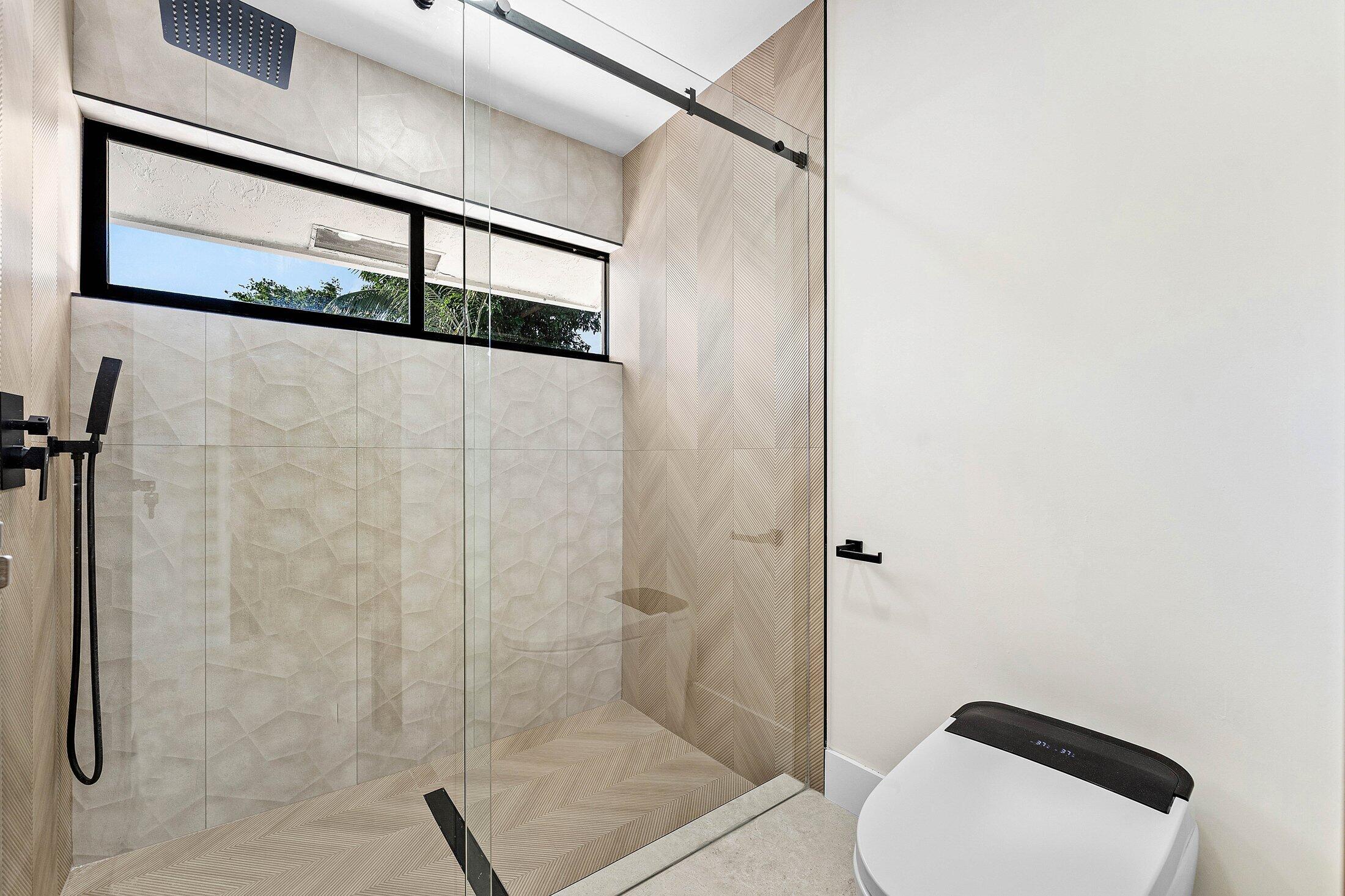 1380 Southwest 1st Street Boca Raton, FL 33486 - Photo 29 of 50 a bathroom with a shower and toilet