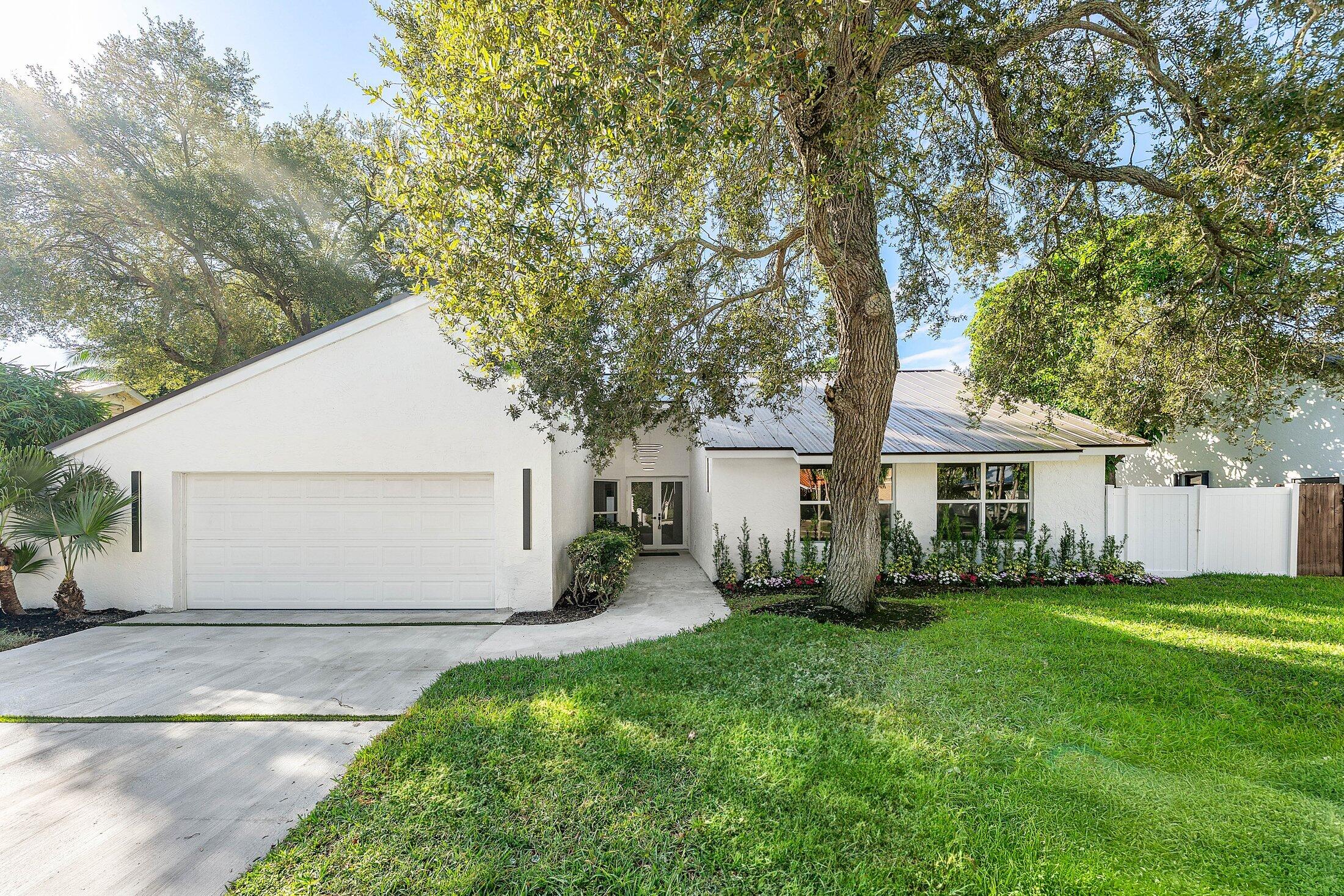 1380 Southwest 1st Street Boca Raton, FL 33486 - Photo 3 of 50 a view of a house with backyard and a tree