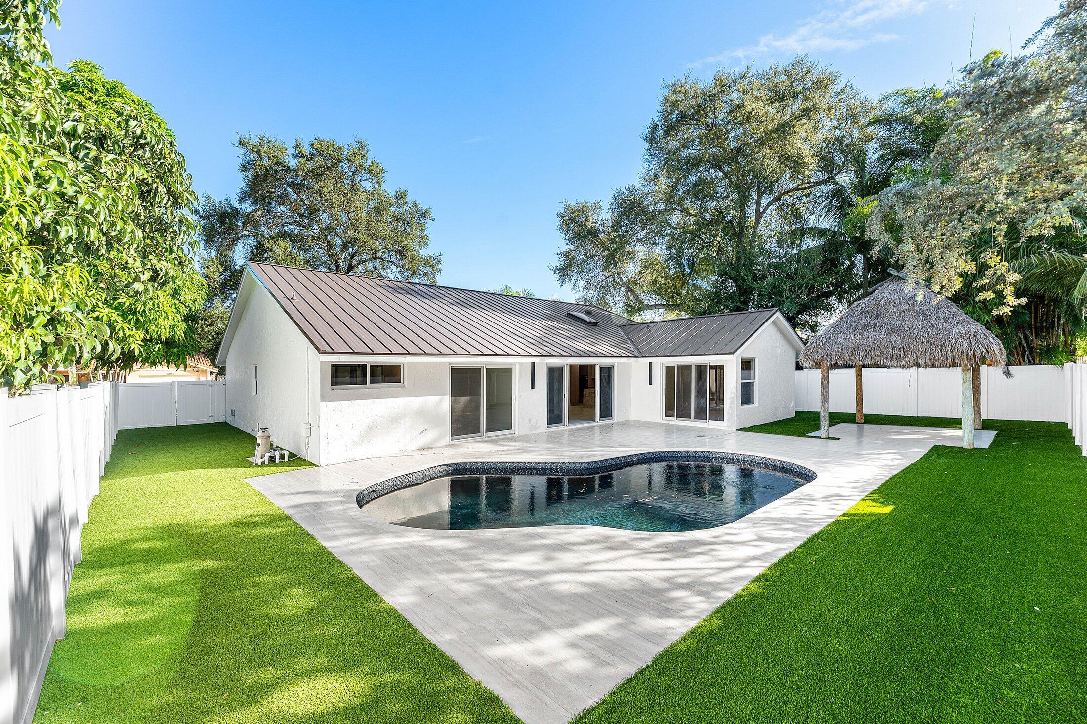 1380 Southwest 1st Street Boca Raton, FL 33486 - Photo 36 of 50 a front view of a house with garden