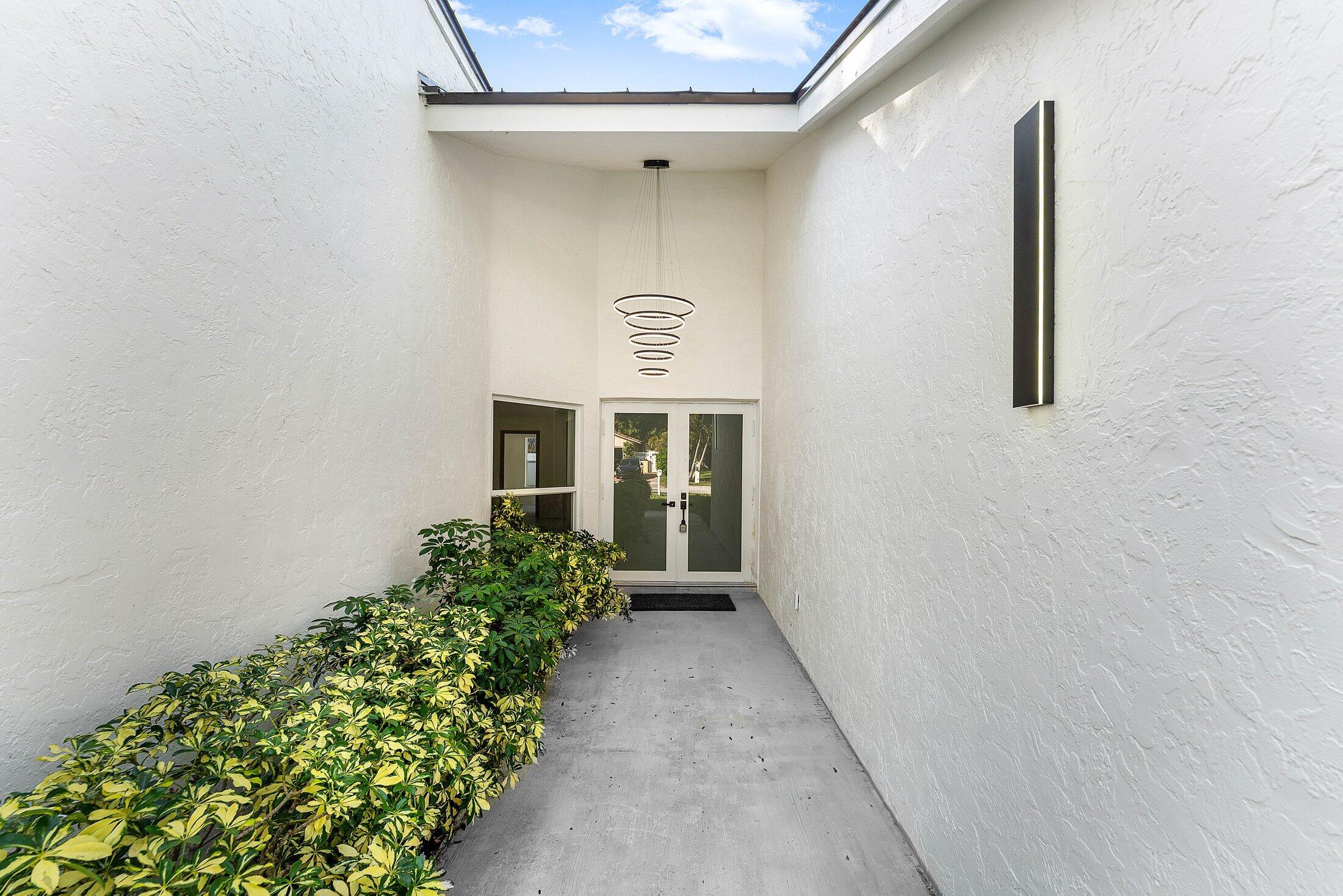 1380 Southwest 1st Street Boca Raton, FL 33486 - Photo 4 of 50 front view of a house with a yard