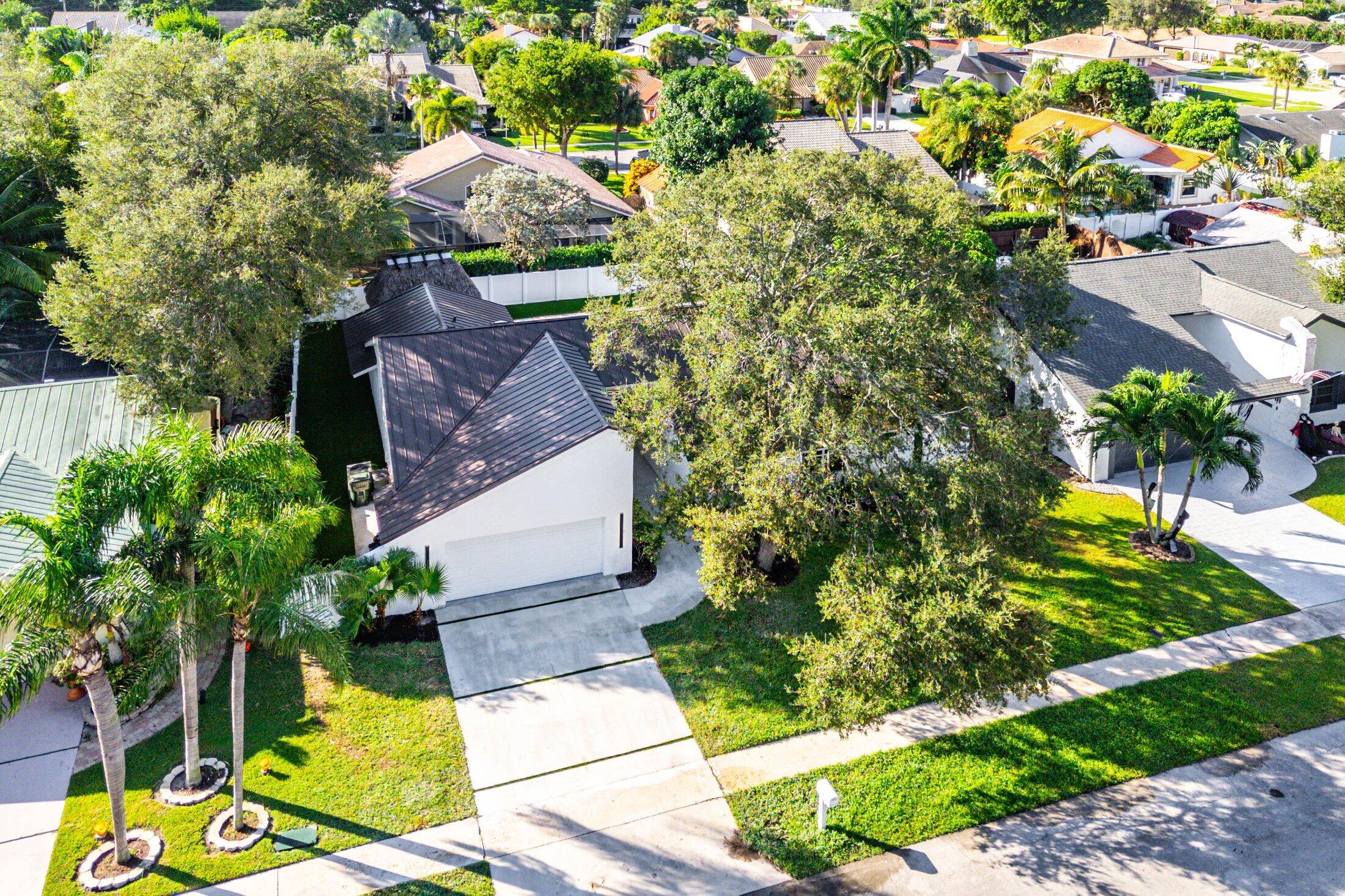 1380 Southwest 1st Street Boca Raton, FL 33486 - Photo 46 of 50 a view of a yard with plants and large trees