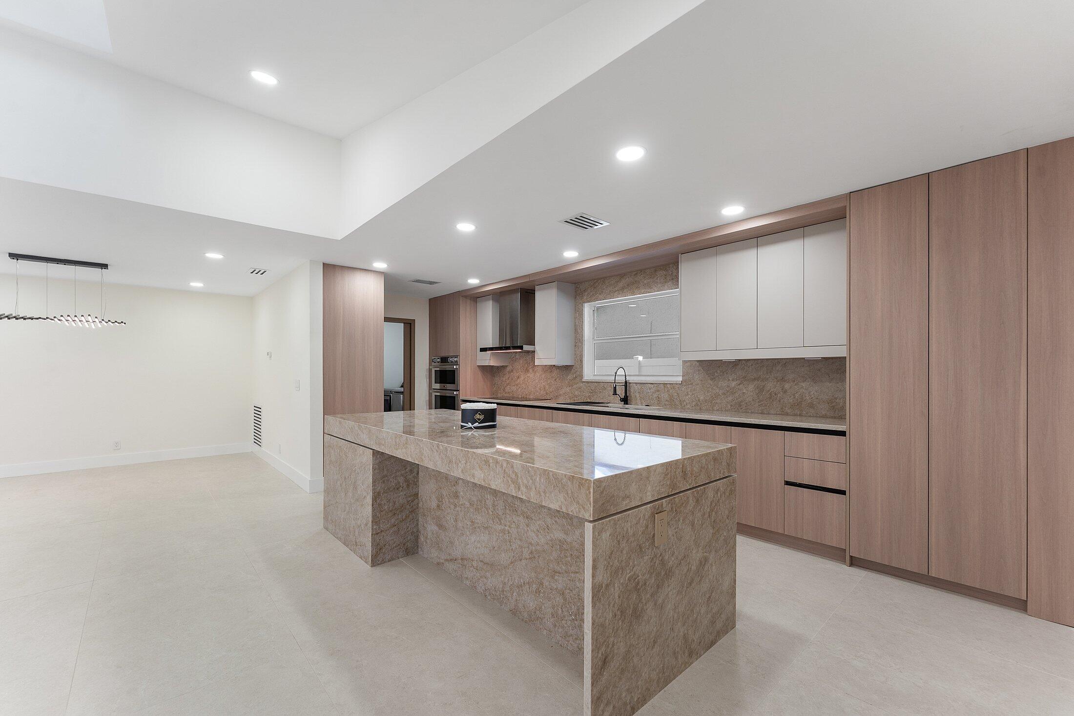 1380 Southwest 1st Street Boca Raton, FL 33486 - Photo 10 of 50 a kitchen with stainless steel appliances appliances a sink and a refrigerator