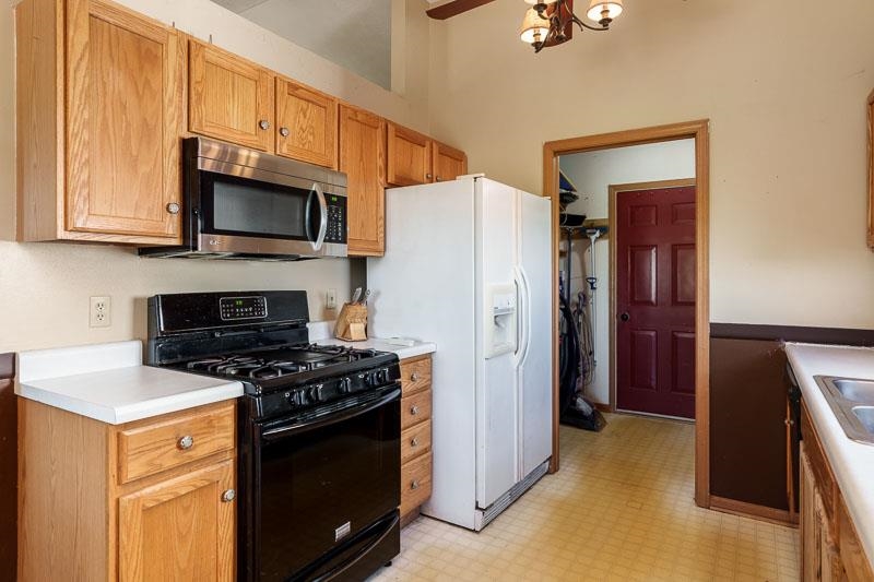 5406 Torque Road Loves Park, IL 61111 - Photo 21 of 40 a kitchen with stainless steel appliances a stove a microwave a sink and cabinets