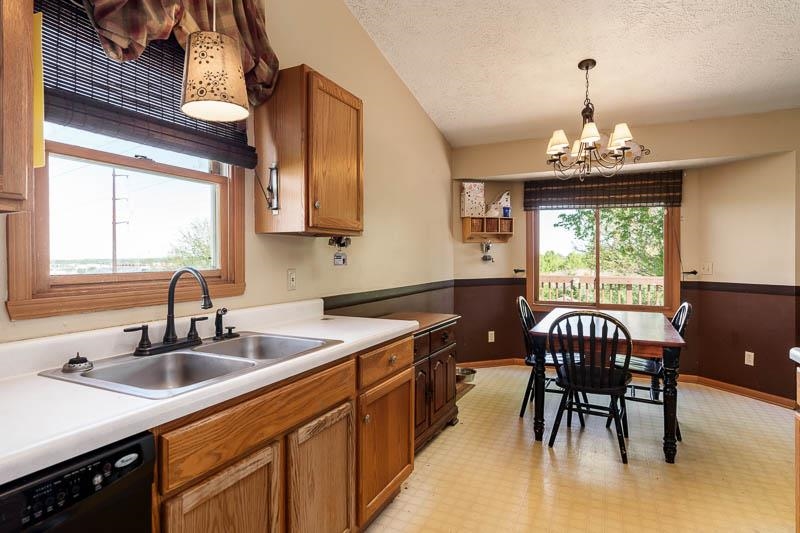 5406 Torque Road Loves Park, IL 61111 - Photo 23 of 40 a kitchen with a table chairs sink and cabinets
