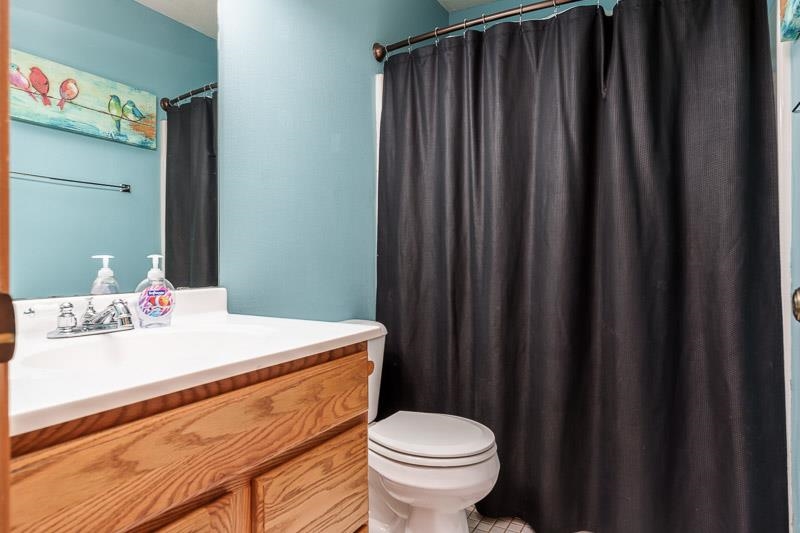 5406 Torque Road Loves Park, IL 61111 - Photo 29 of 40 a bathroom with a sink a toilet and shower curtain