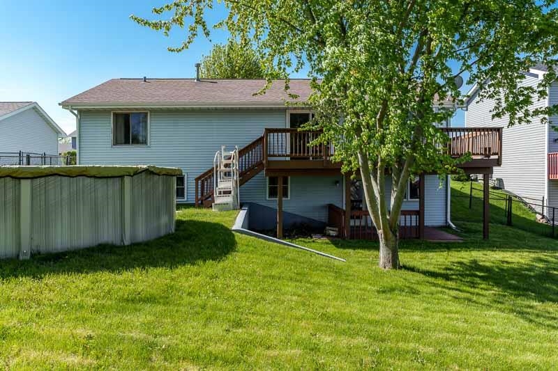 5406 Torque Road Loves Park, IL 61111 - Photo 5 of 40 a view of a house with a yard potted plants and a large tree