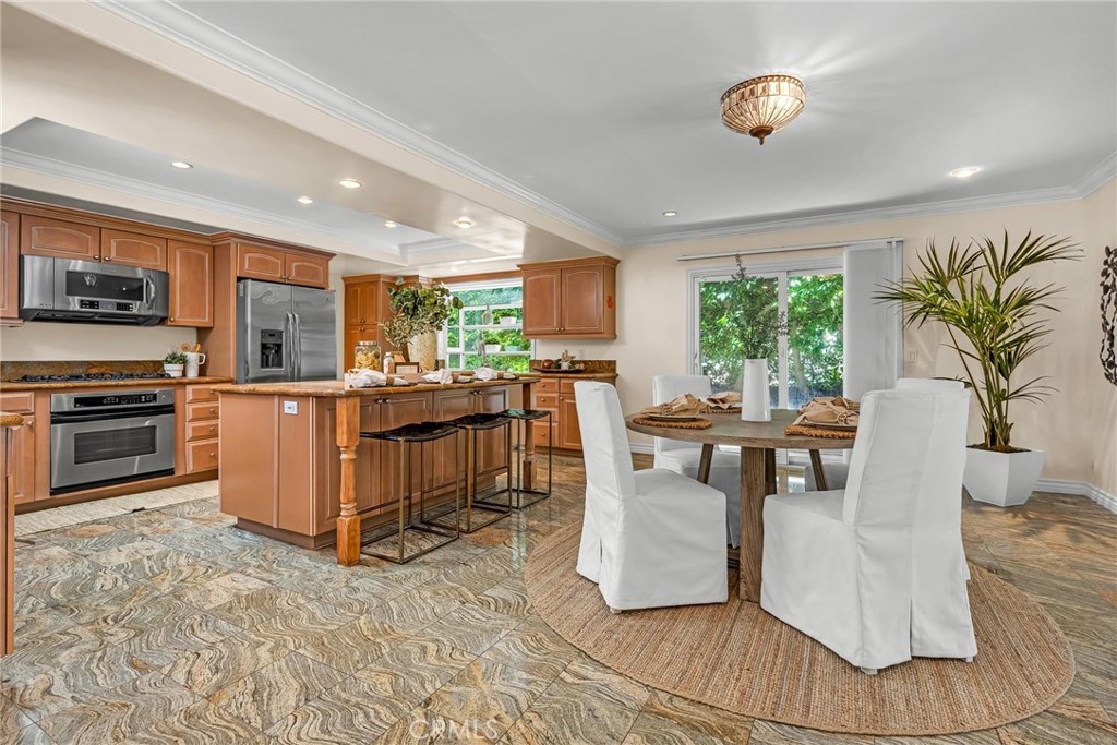 28084 Ella Road Rancho Palos Verdes, CA 90275 - Photo 11 of 38 a kitchen with stainless steel appliances a stove a sink a microwave a dining table and chairs
