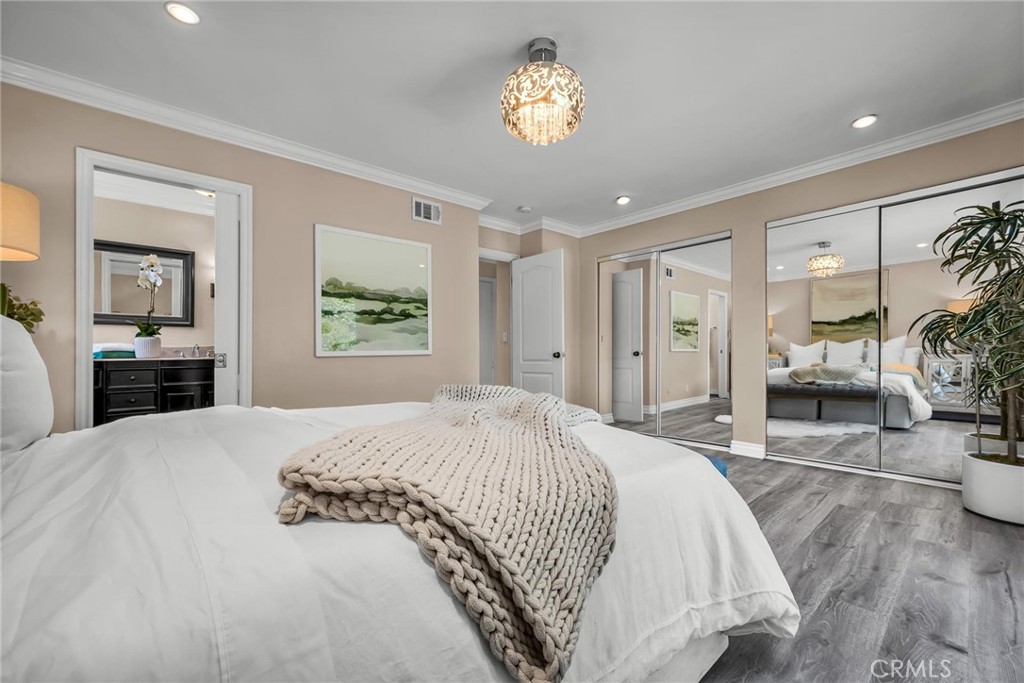 28084 Ella Road Rancho Palos Verdes, CA 90275 - Photo 16 of 38 a spacious bedroom with a large bed and a chandelier