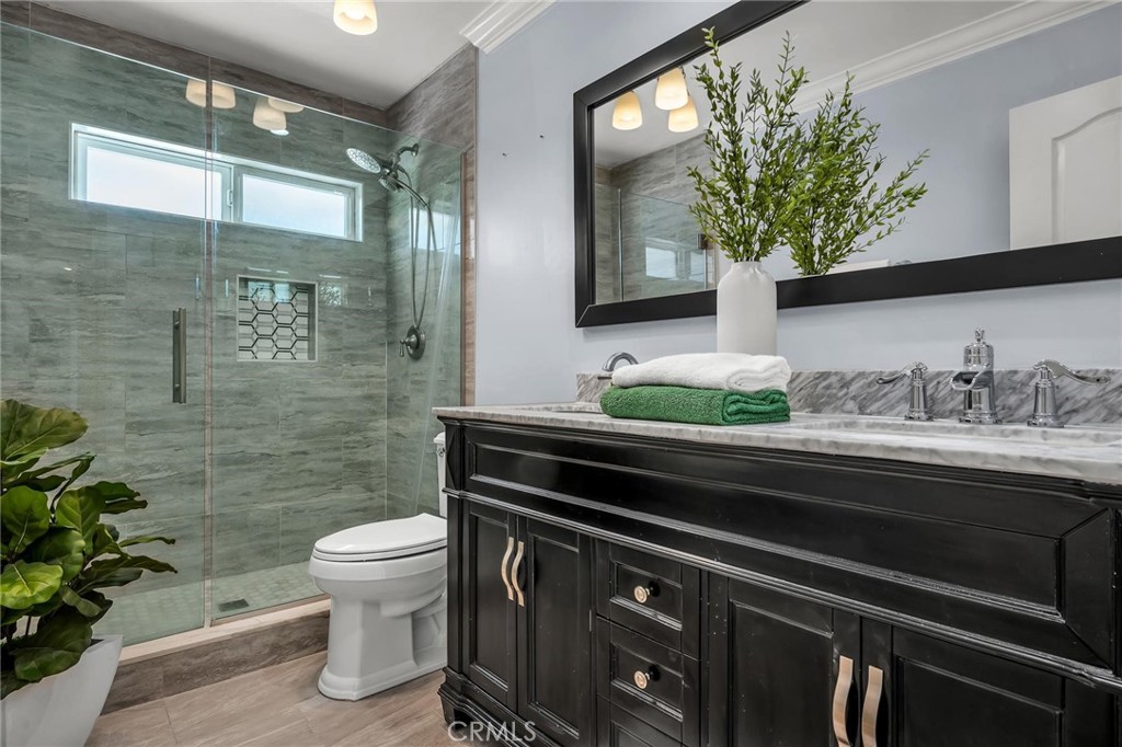 28084 Ella Road Rancho Palos Verdes, CA 90275 - Photo 20 of 38 a bathroom with a granite countertop sink a toilet and mirror