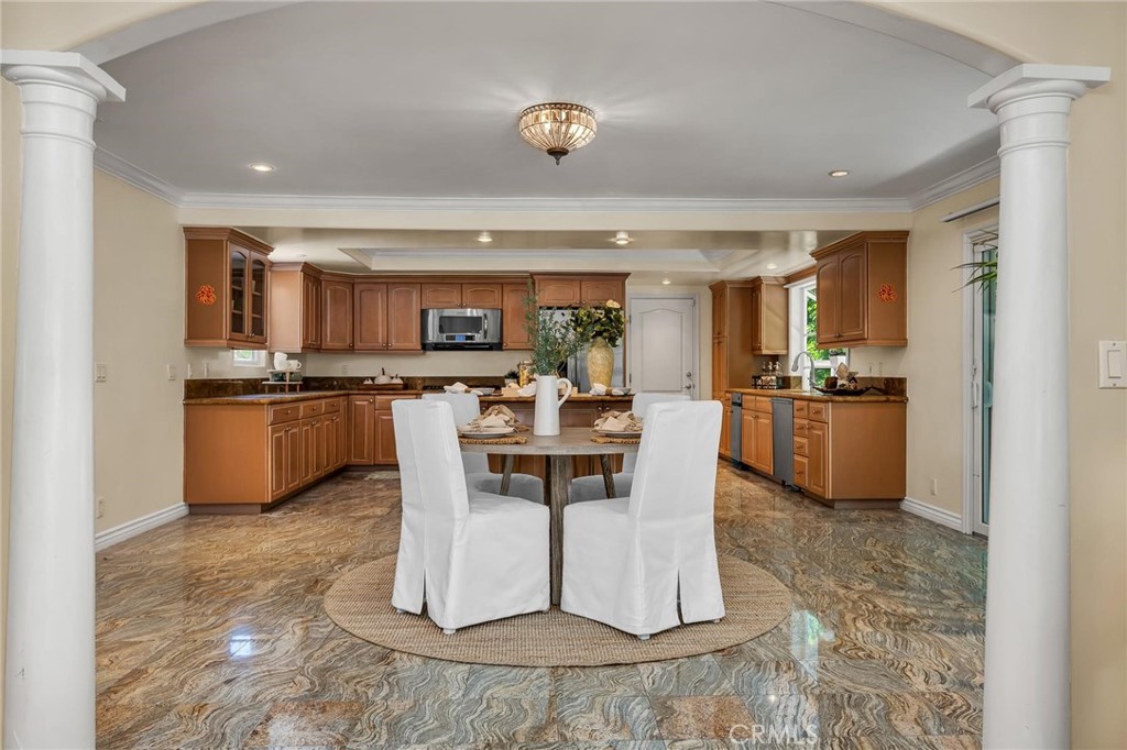 28084 Ella Road Rancho Palos Verdes, CA 90275 - Photo 9 of 38 a kitchen with a dining table chairs cabinets and stainless steel appliances