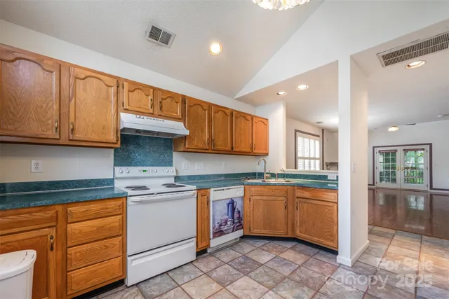 a kitchen with stainless steel appliances granite countertop a sink and cabinets