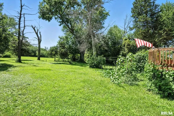 a view of a house with a deck area and garden