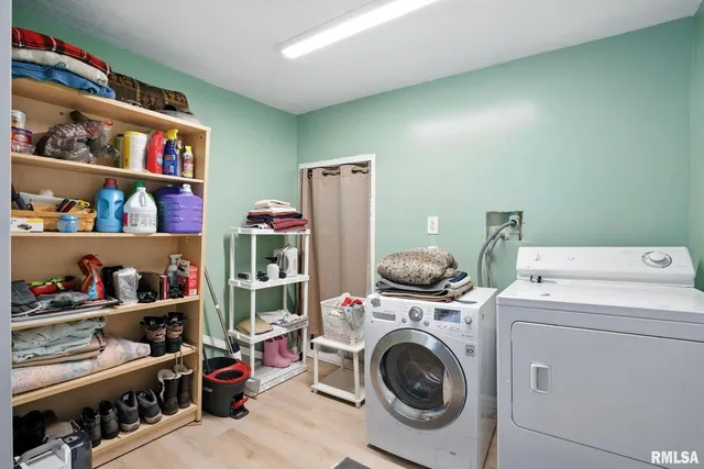 a utility room with dryer washer and closet