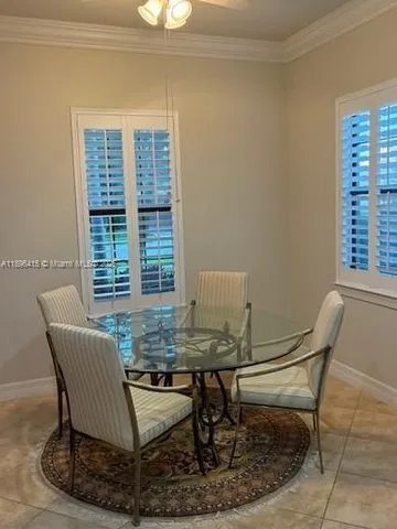 a dining room with furniture and window