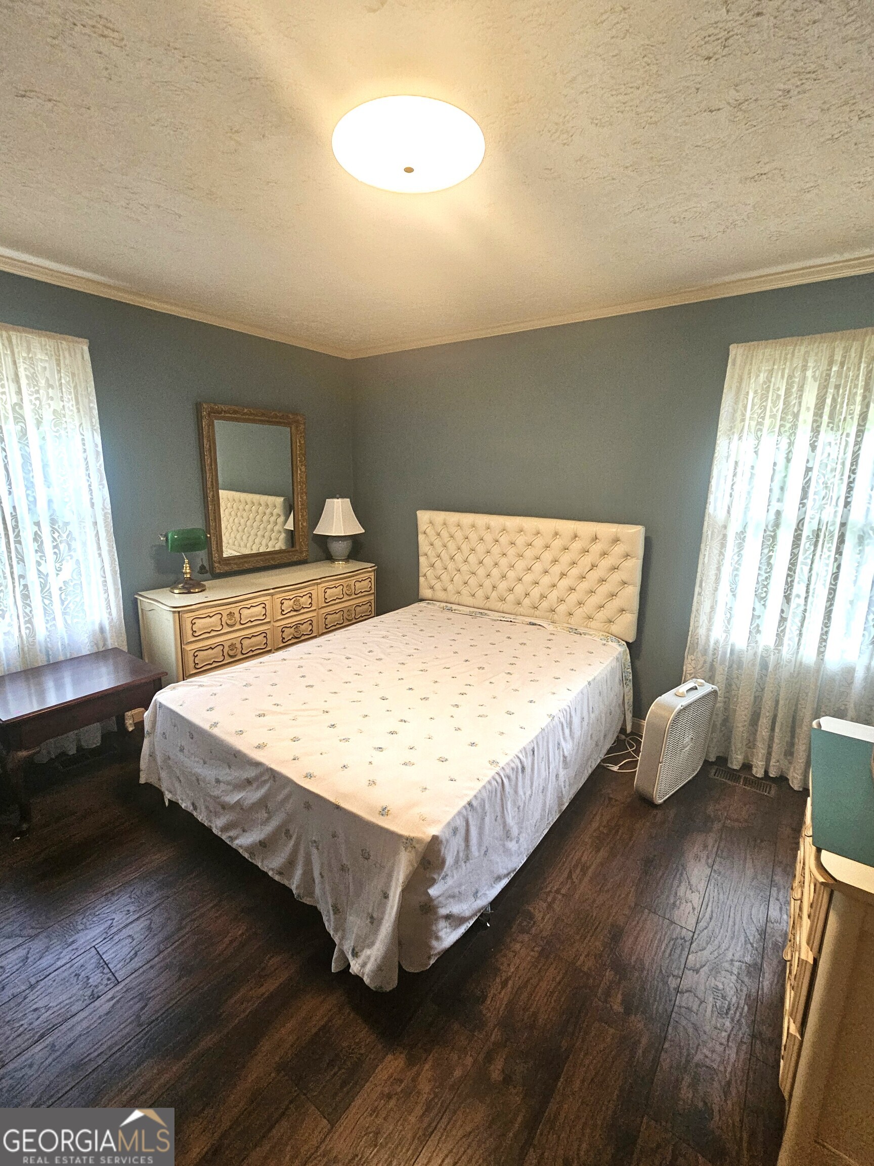 613 Old Macon Road Dublin, GA 31021 - Photo 13 of 17 a bedroom with a bed and wooden floor