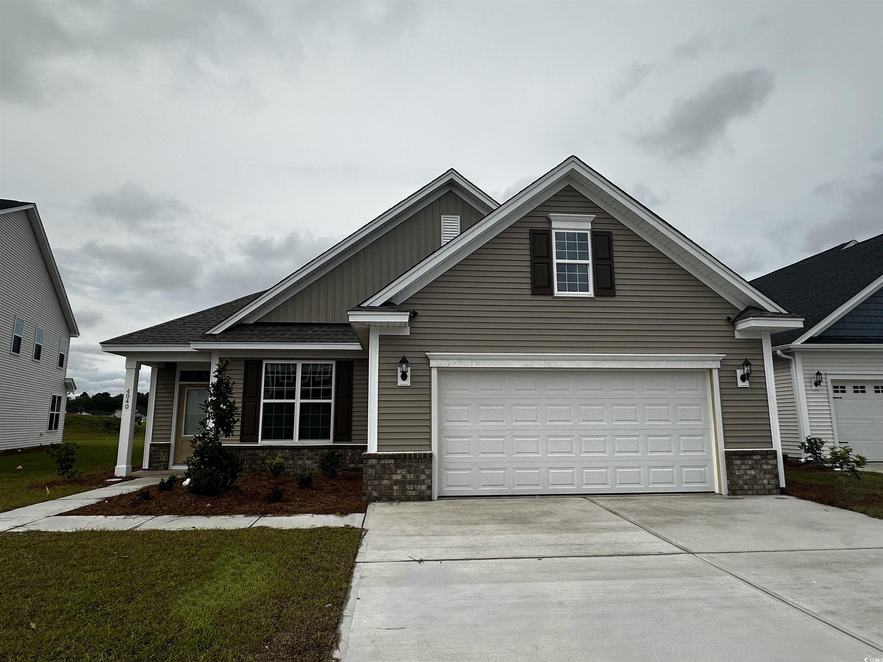 4040 Bucolic Loop Myrtle Beach, SC 29588 - Photo 1 of 13 Craftsman inspired home with driveway, a garage, a