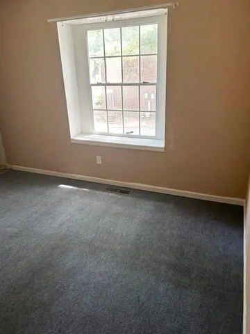 an empty room with a mirror