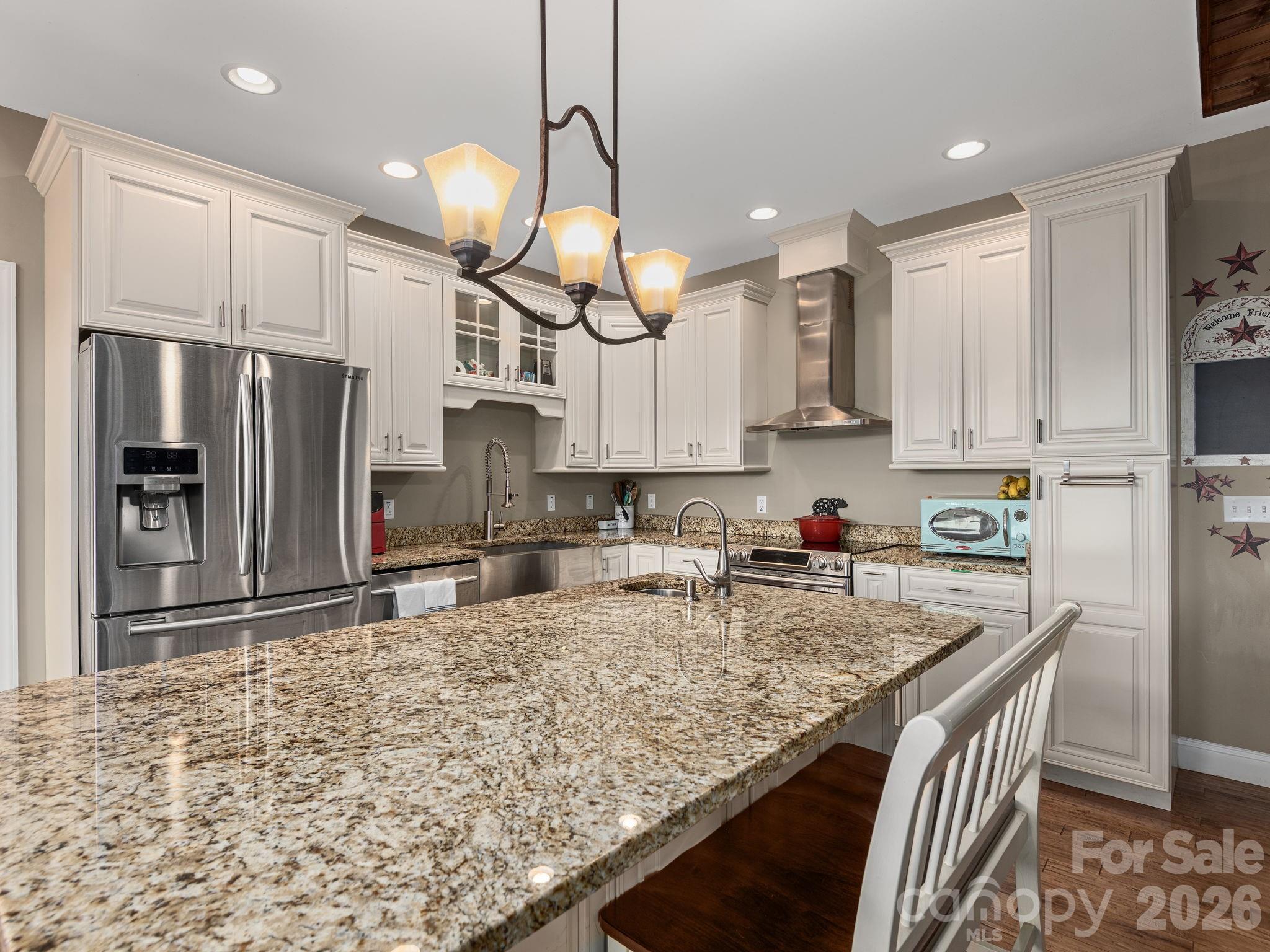 193 Youngs Cove Road Candler, NC 28715 - Photo 11 of 48 a kitchen with stainless steel appliances granite countertop a sink refrigerator and cabinets