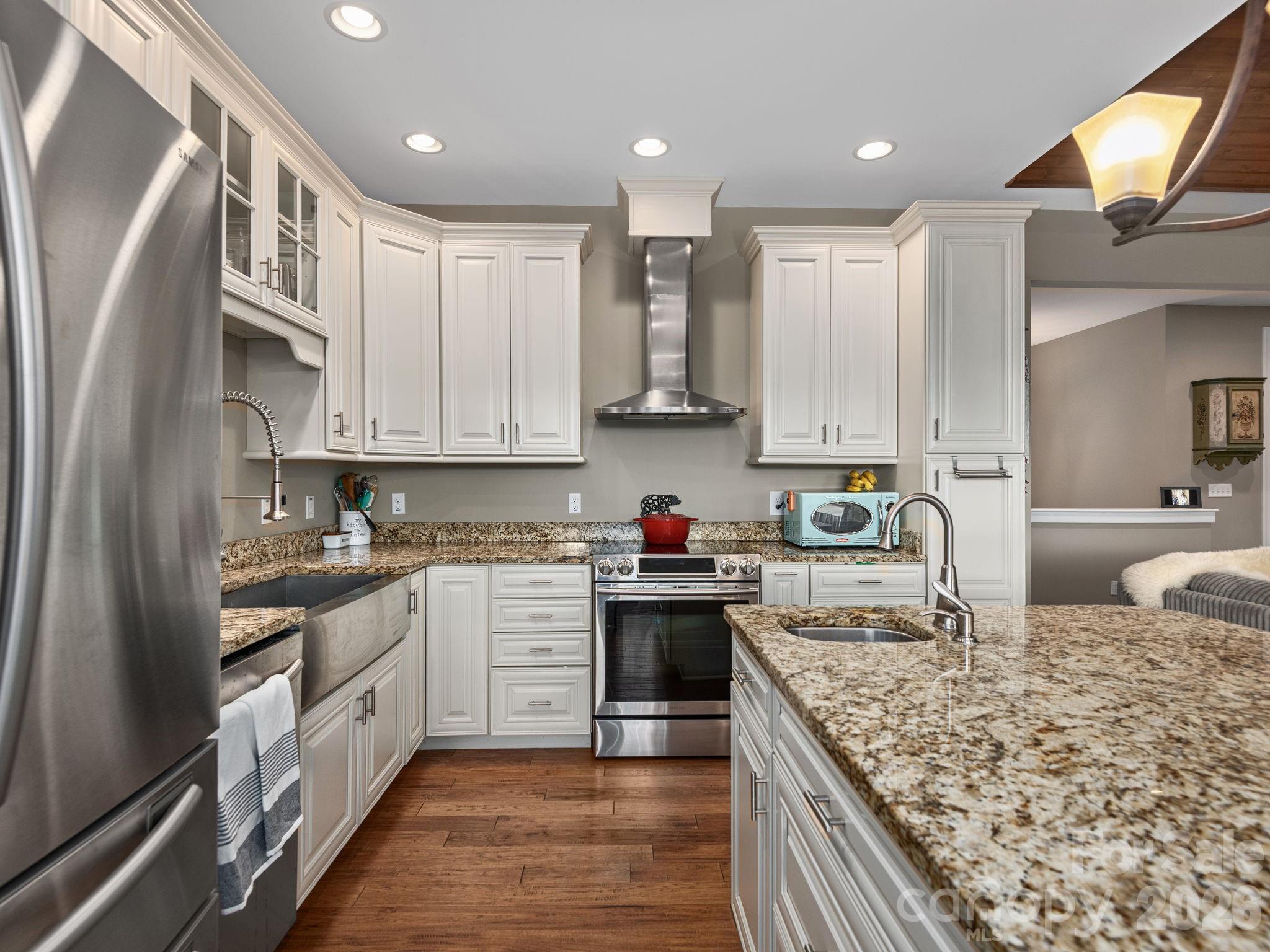 193 Youngs Cove Road Candler, NC 28715 - Photo 12 of 48 a large kitchen with stainless steel appliances granite countertop a stove sink and cabinets