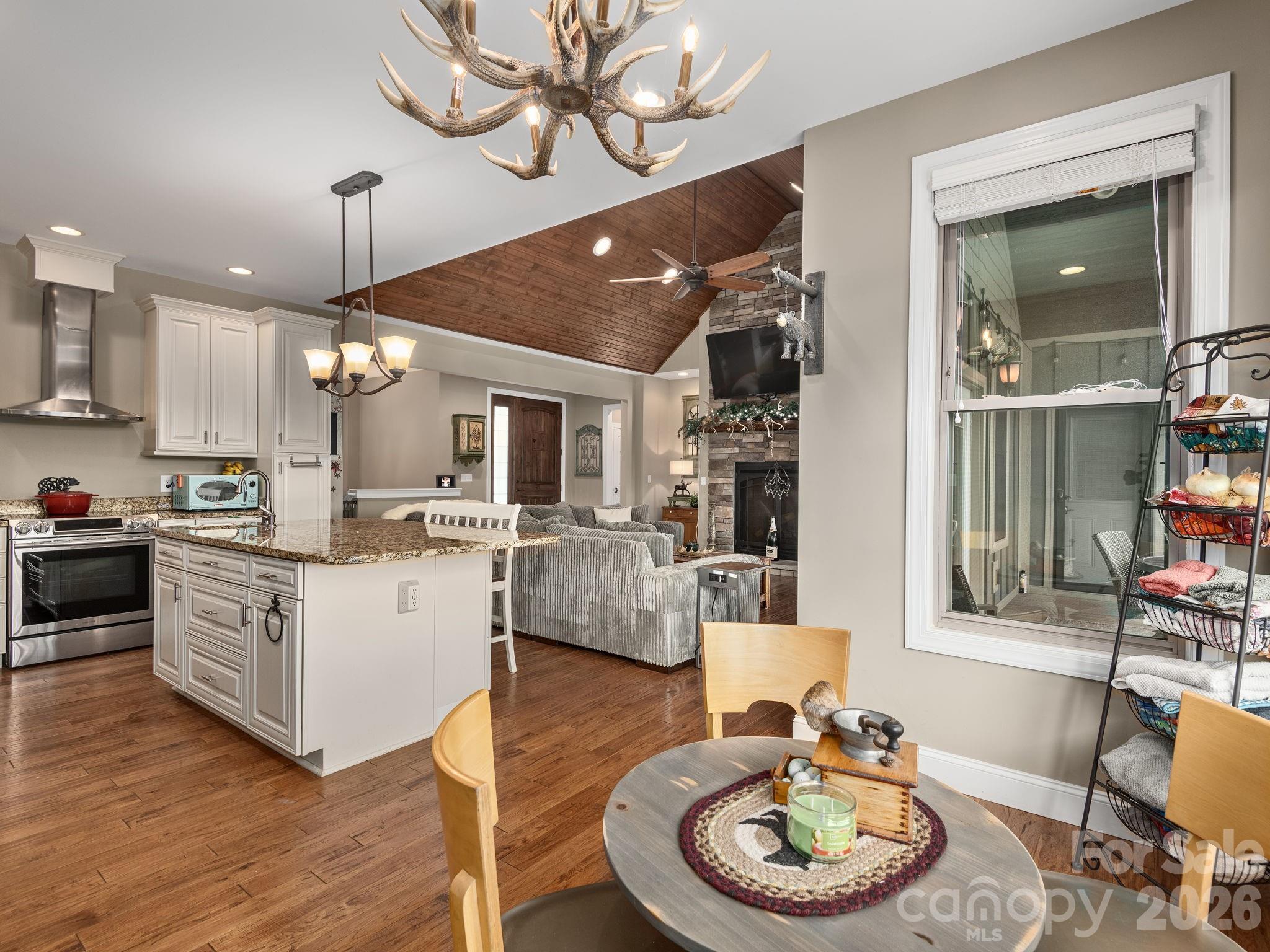 193 Youngs Cove Road Candler, NC 28715 - Photo 14 of 48 a living room with furniture kitchen and a chandelier