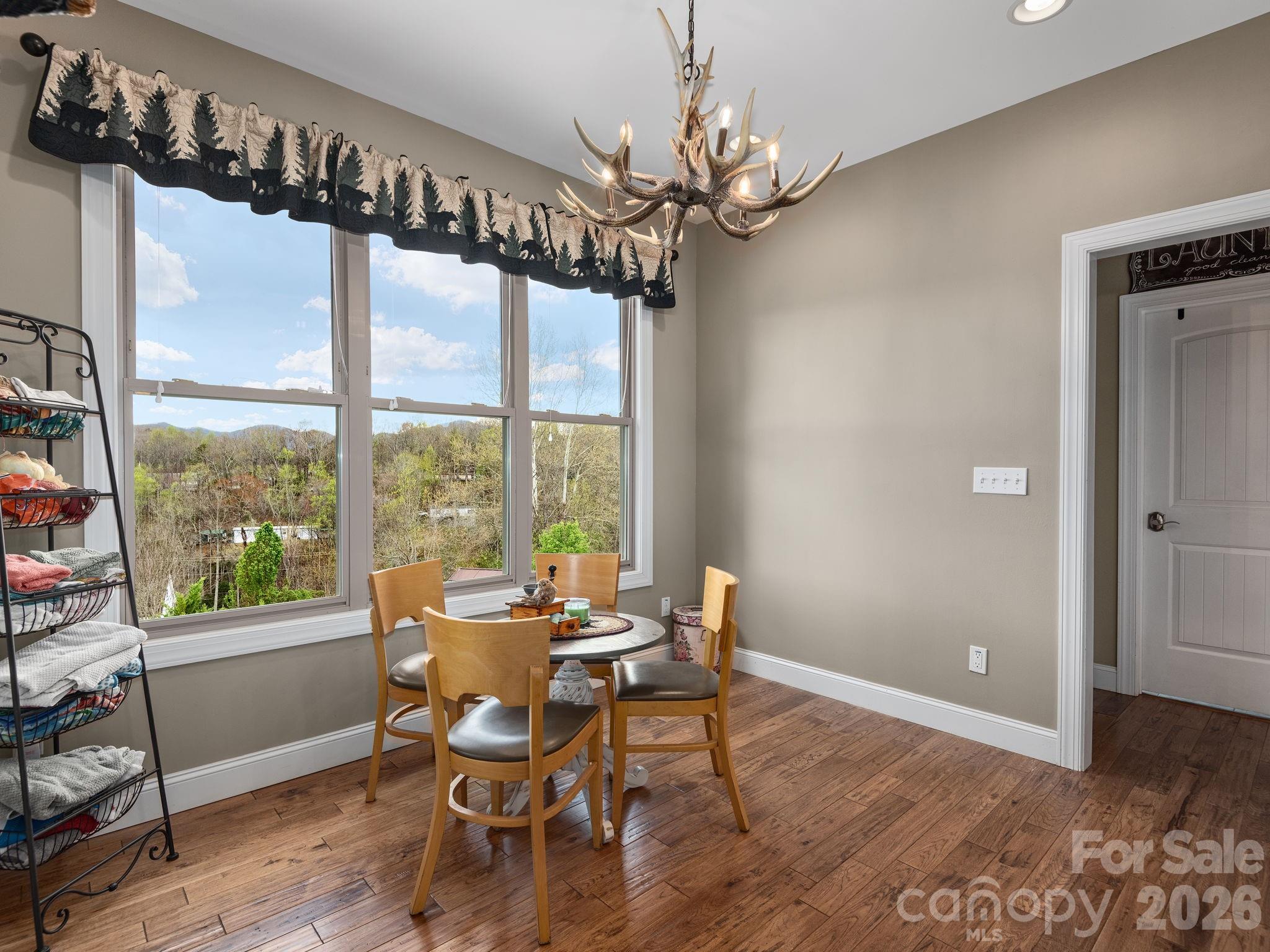 193 Youngs Cove Road Candler, NC 28715 - Photo 15 of 48 a view of a dining room with furniture window and wooden floor