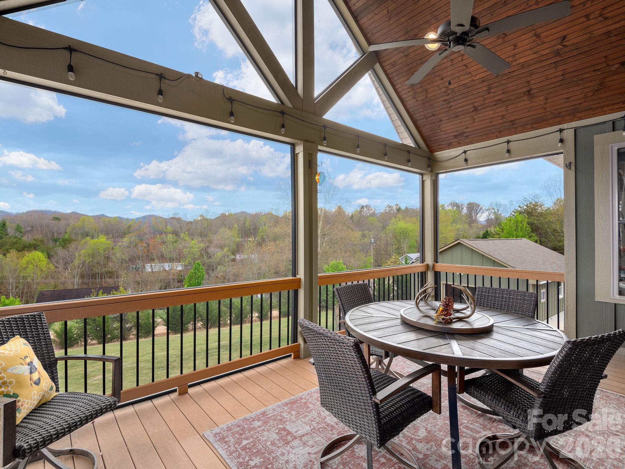 193 Youngs Cove Road Candler, NC 28715 - Photo 19 of 48 a view of a balcony furniture and wooden floor