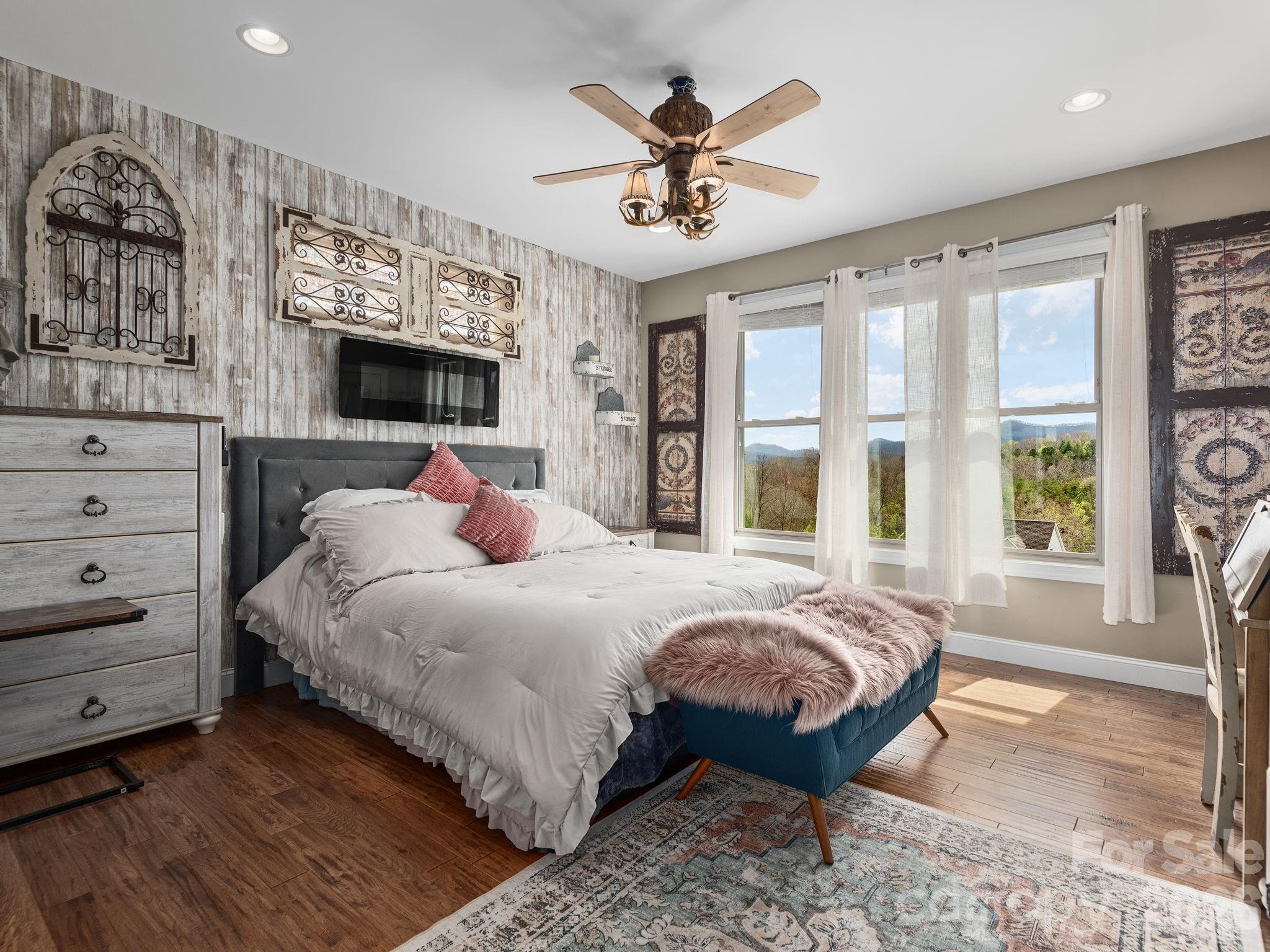 193 Youngs Cove Road Candler, NC 28715 - Photo 20 of 48 a bedroom with a large bed and a large window