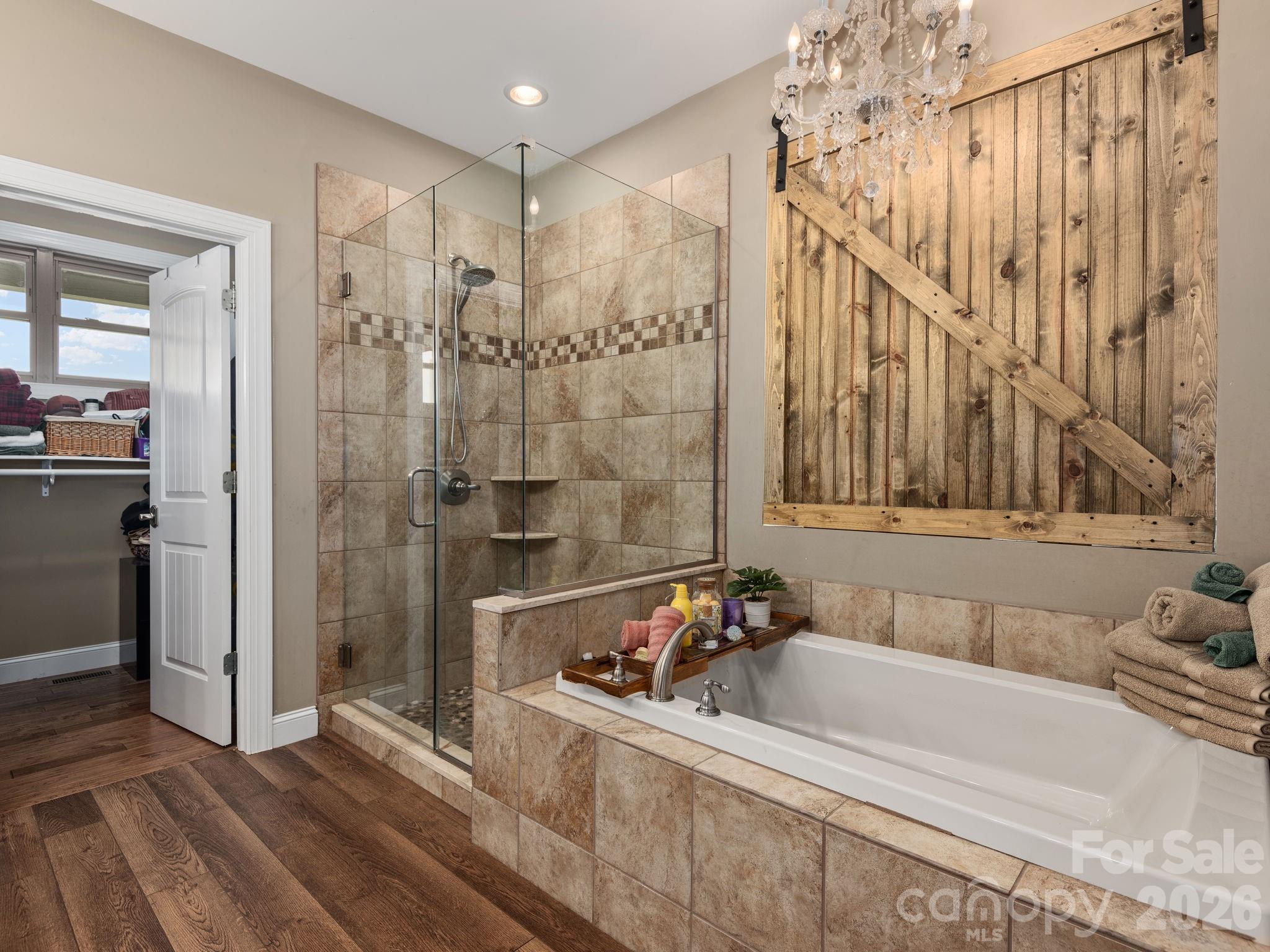 193 Youngs Cove Road Candler, NC 28715 - Photo 21 of 48 a bathroom with a bathtub and a shower